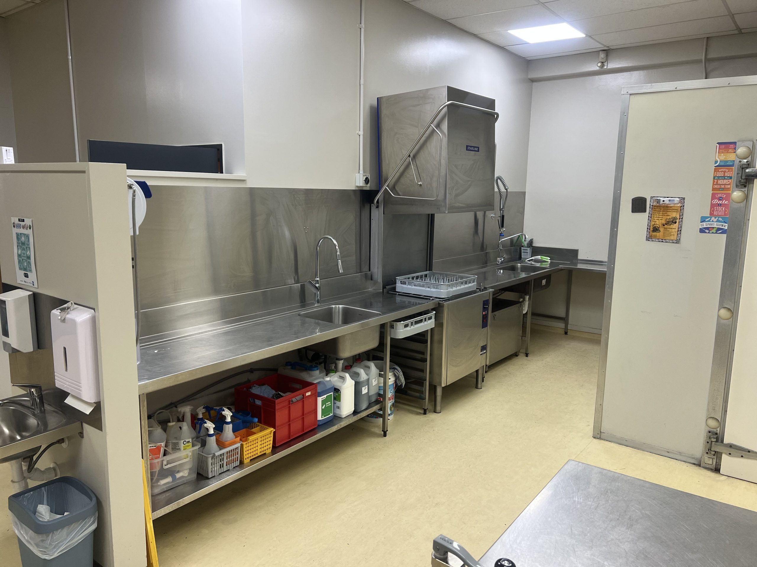 Commercial wash-up area with passthrough dishwasher and sinks